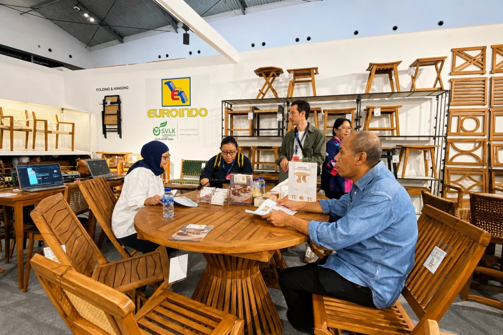 Euroindo Jaya team discussing furniture products with international buyers during a furniture trade exhibition